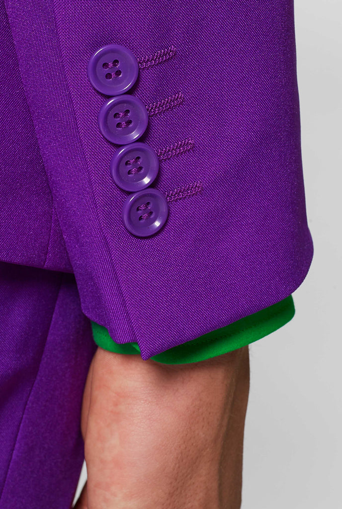 Man wearing purple men's suit and green dress shirt, sleeve close up