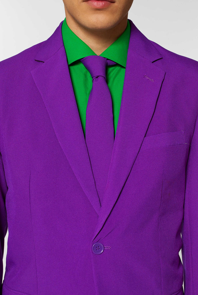 Man wearing purple men's suit and green dress shirt, close up