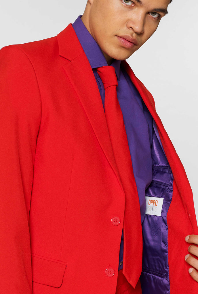 Man wearing red men's suit with purple dress shirt, close up