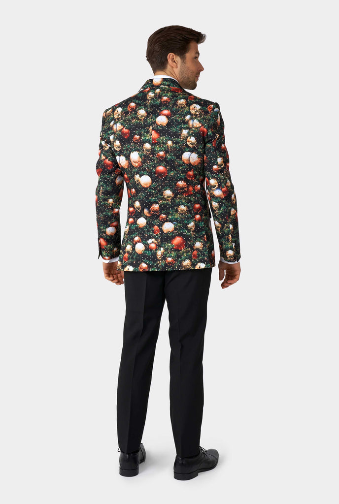 Man wearing Christmas suit with Christmas tree print view from the back