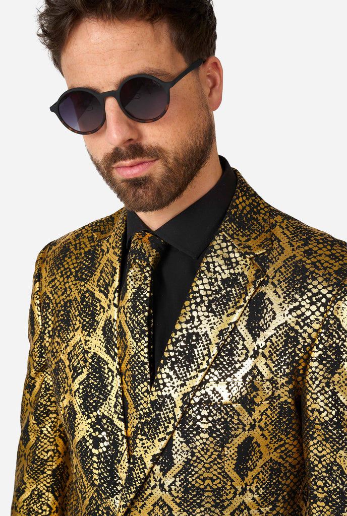 Man wearing suit with, gold and black, snakeskin print