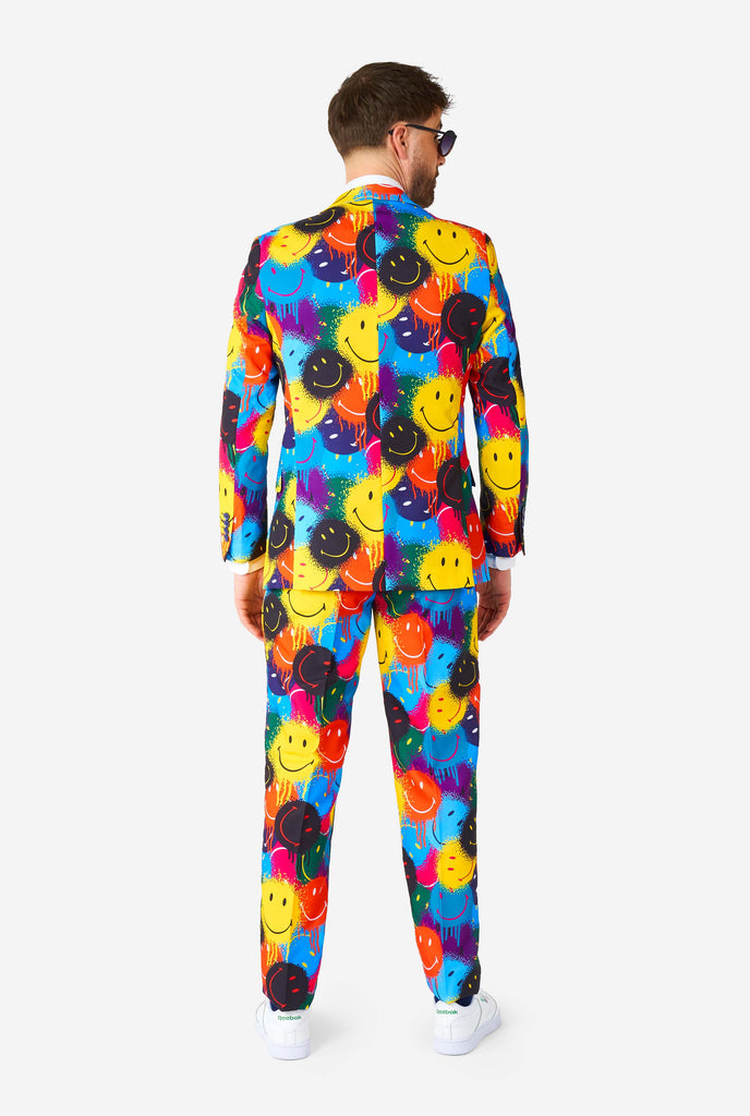 Man wearing colorful men's suit with Smiley print, view from the back