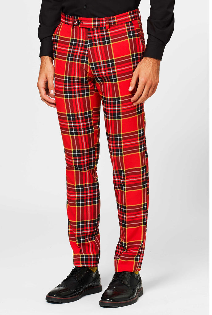 Man wearing red Christmas tartan men's suit, pants close up