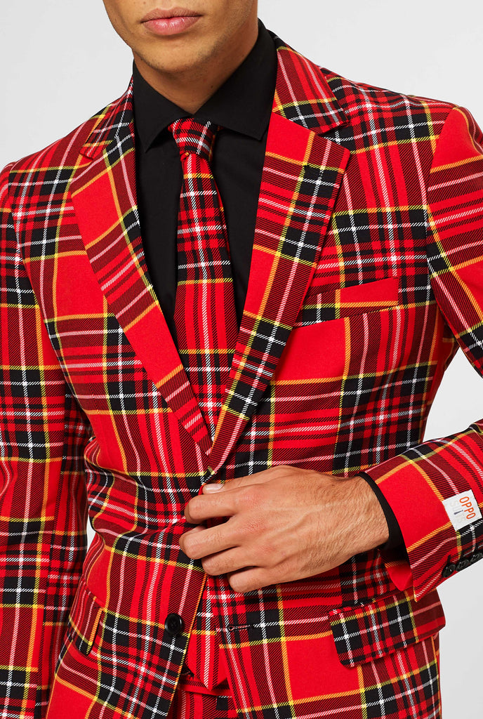 Man wearing red Christmas tartan men's suit, close up