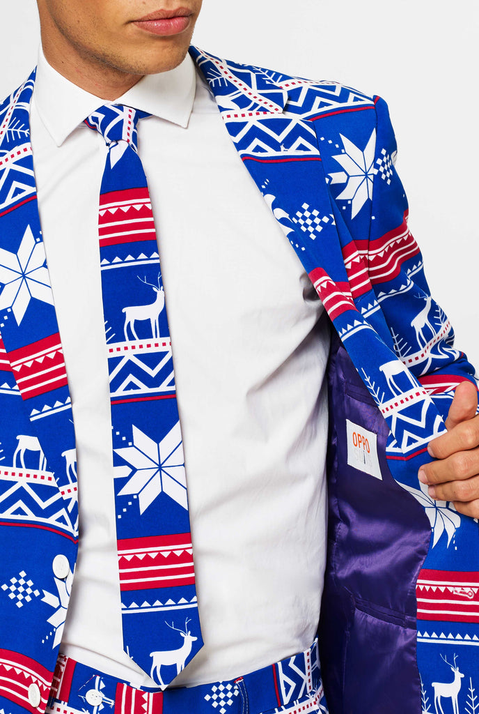 Man wearing blue Christmas suit with Nordic themed print, close up