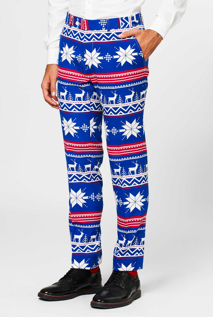 Man wearing blue Christmas suit with Nordic themed print, pants close up