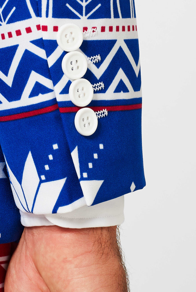 Man wearing blue Christmas suit with Nordic themed print, sleeve close up