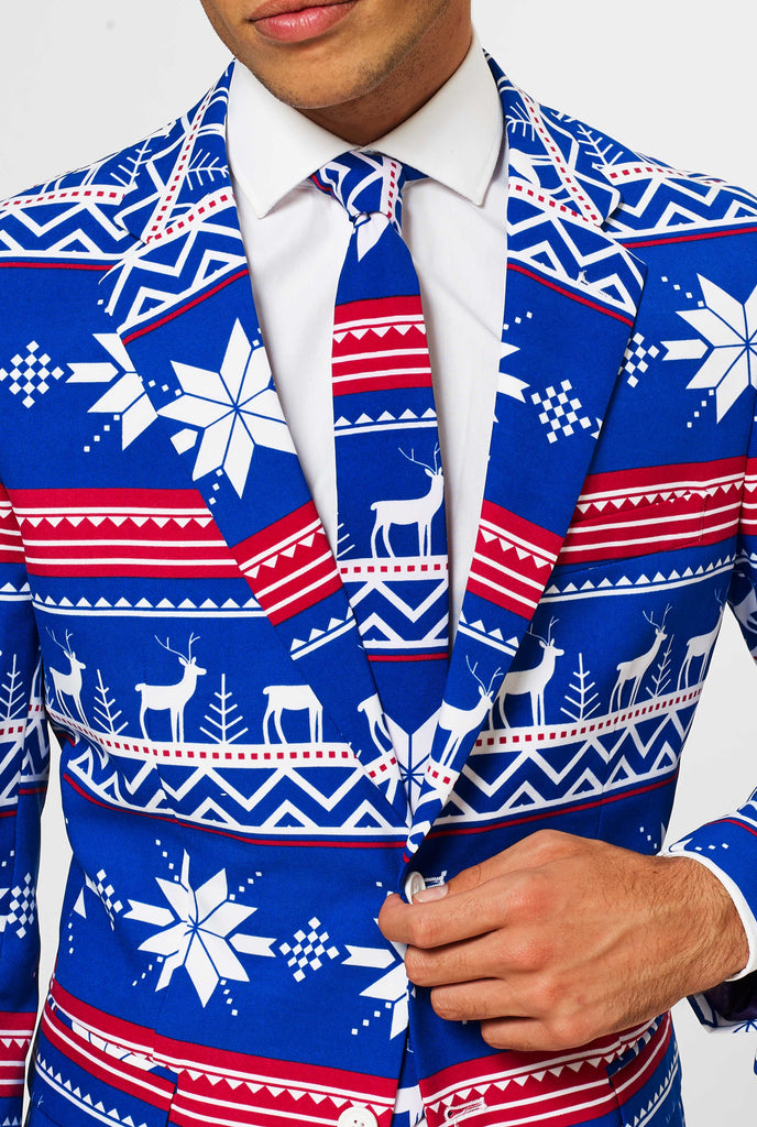 Man wearing blue Christmas suit with Nordic themed print, close up