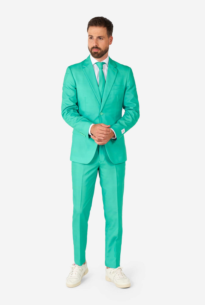 Man wearing turquoise colored suit