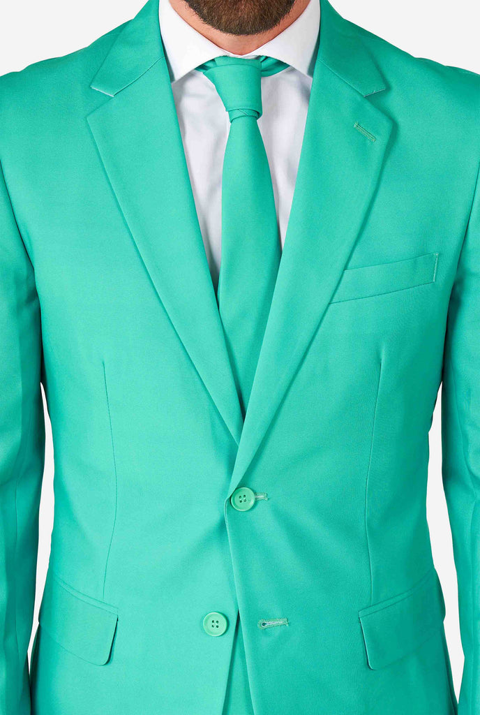 Man wearing turquoise colored suit