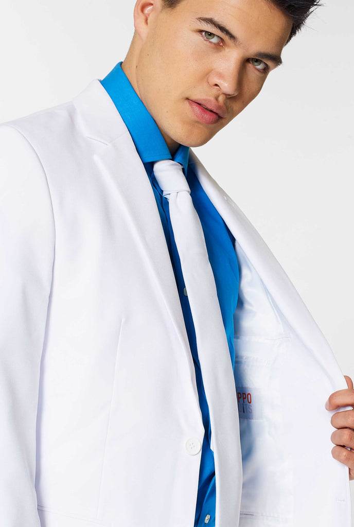 All white suit worn by man showing inside of jacket