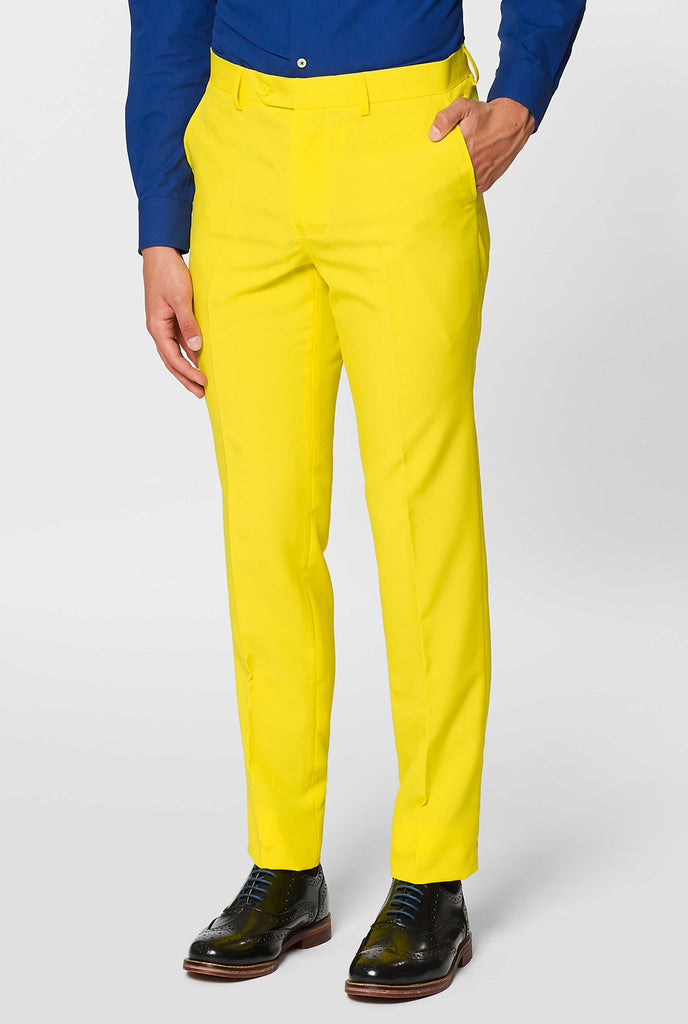 Man wearing yellow men's suit and dark blue dress shirt, pants close up