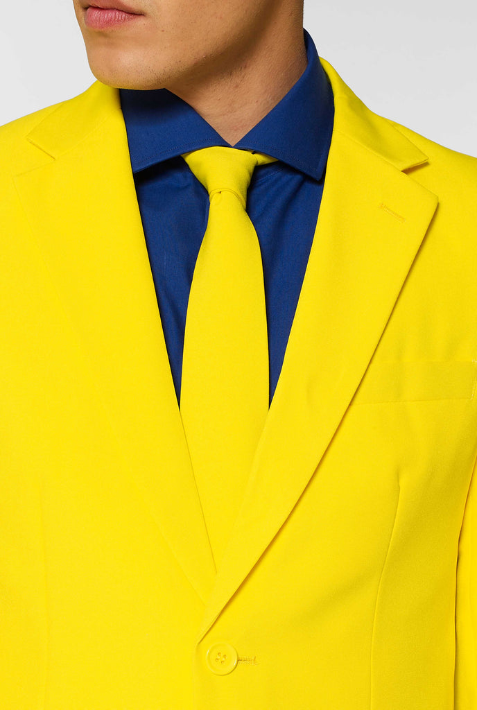 Man wearing yellow men's suit and dark blue dress shirt, close up