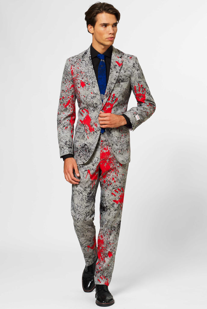 Man wearing grey Halloween men's suit with blood stains