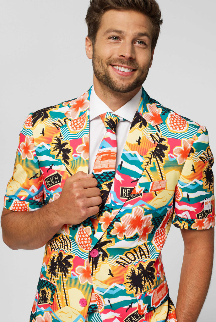 Man wearing colorful Hawaiian print summer suit, consisting of short, jacket and tie, close up