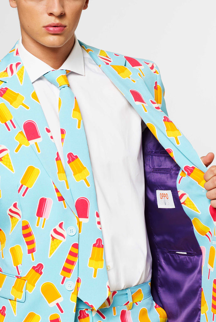 Man wearing light blue summer suit with popsicle print, close up