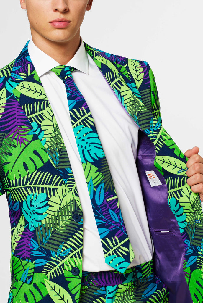 Man wearing green summer suit with jungle leaf print, close up