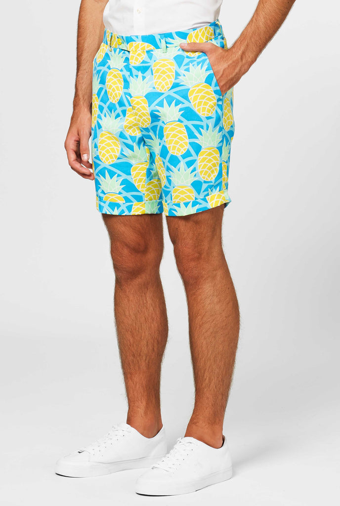 Man wearing blue summer suit with pineapple print, close up of pants