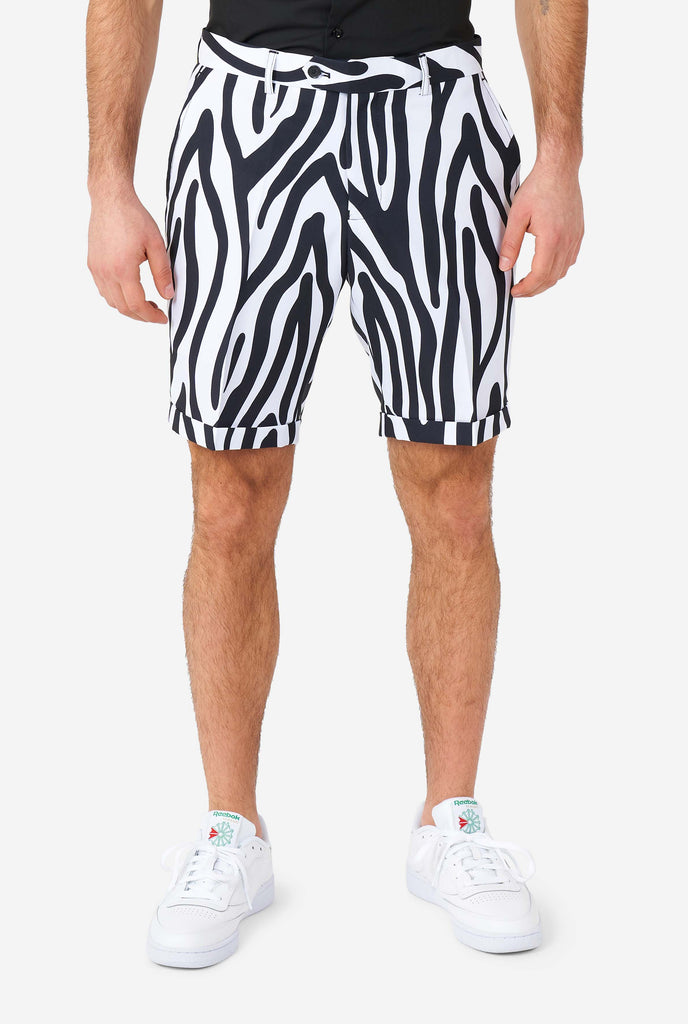 Man wearing summer suit with black and white zebra stripes, close up of pants