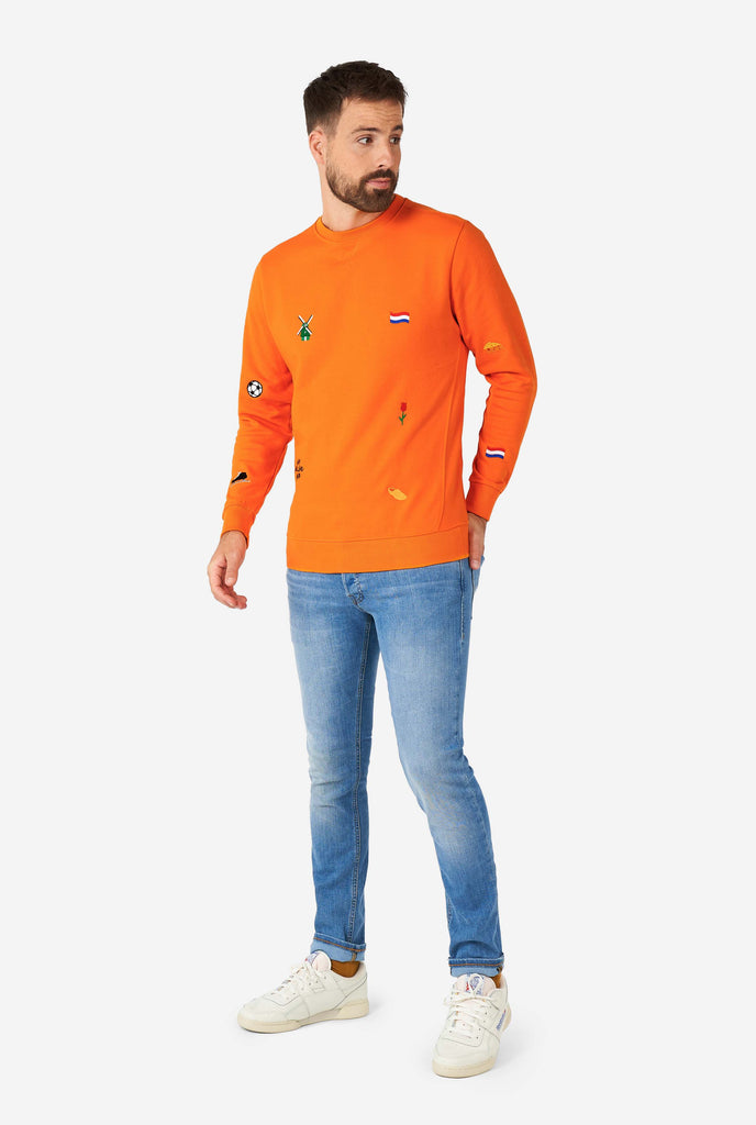 Man wearing orange sweater with Dutch icons