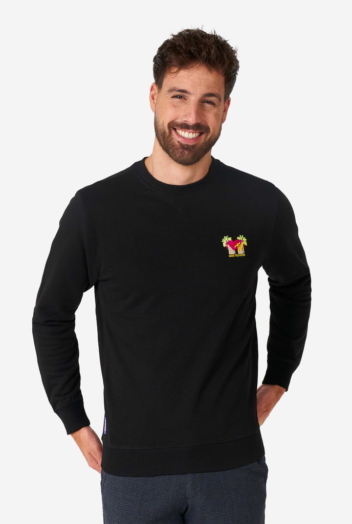 Man wearing black sweater with MTV embroidery.