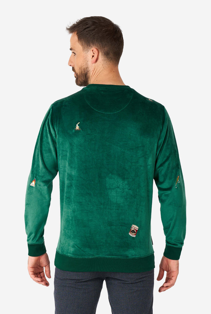 Man wearing velvet green Christmas sweater with Christmas icons, view from the back