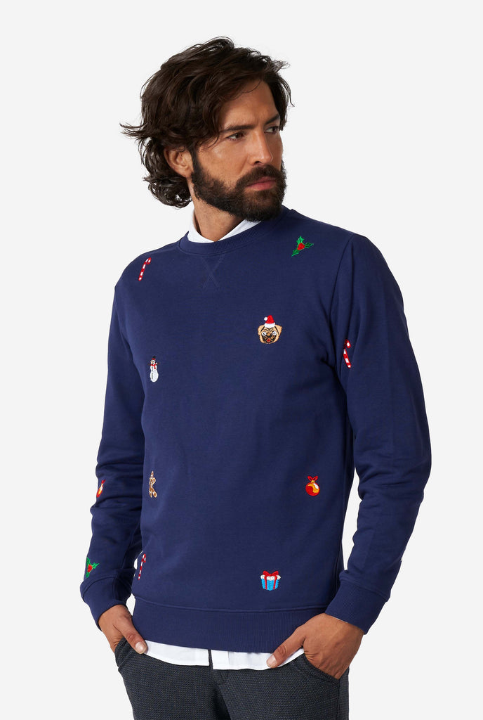 Man wearing blue Christmas sweater with Christmas icons