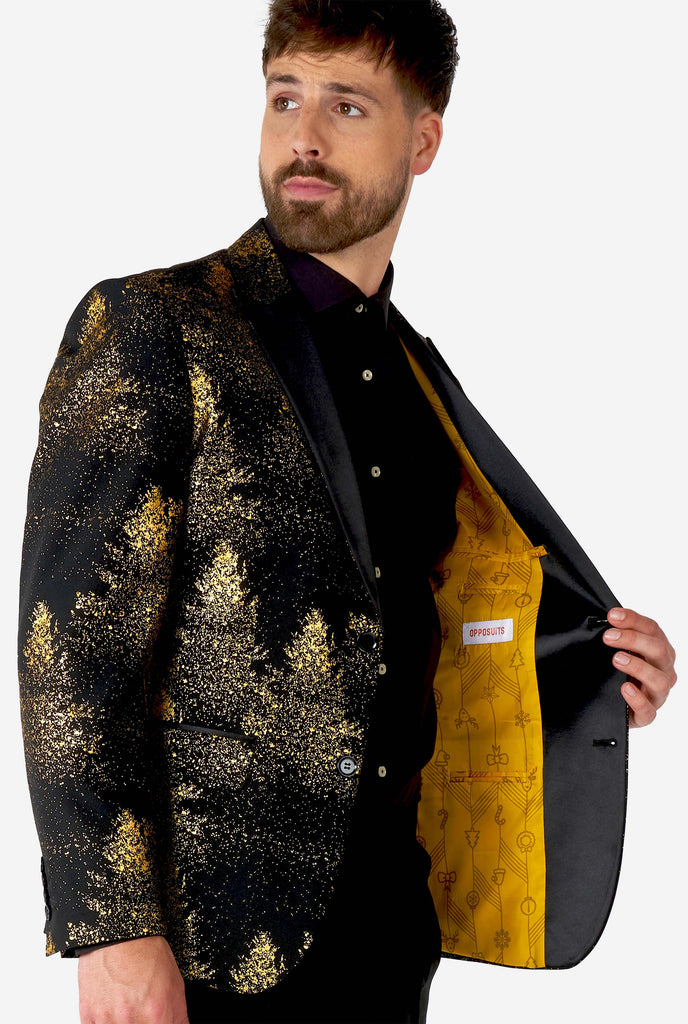 Man wearing black blazer with golden Christmas tree print