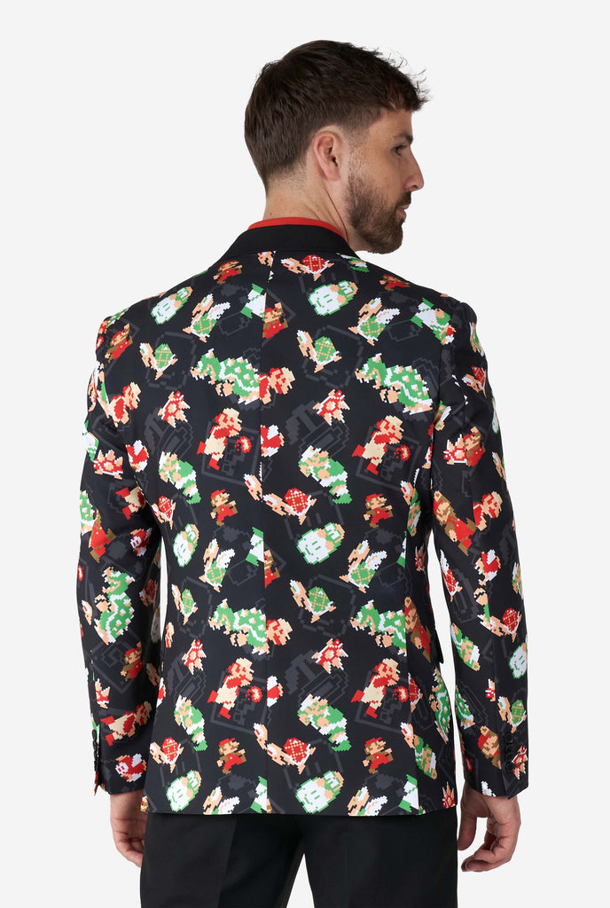 Man wearing black blazer with retro Super Mario characters print, view from the back