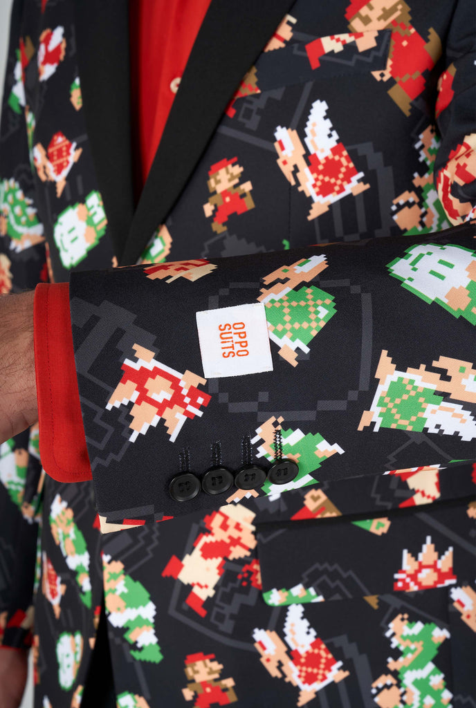 Man wearing black blazer with retro Super Mario characters print, close up