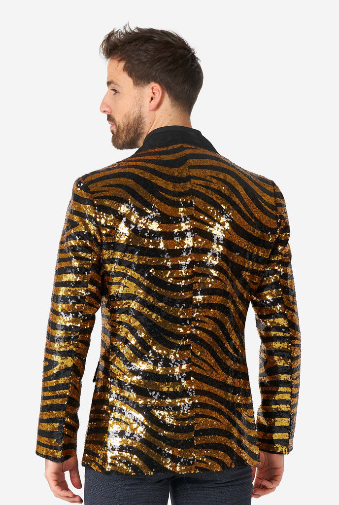 Man wearing black and gold sequins tiger stripe blazer, view from the back