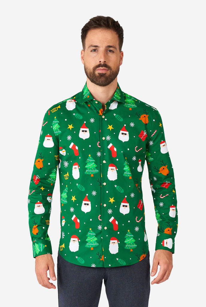 Man wearing green Christmas dress shirt with Christmas icons