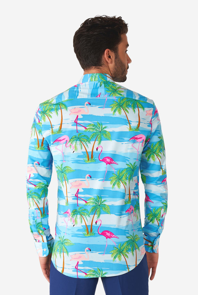 Man wearing Hawaiian dress shirt with tropical flamingo print, view from the back