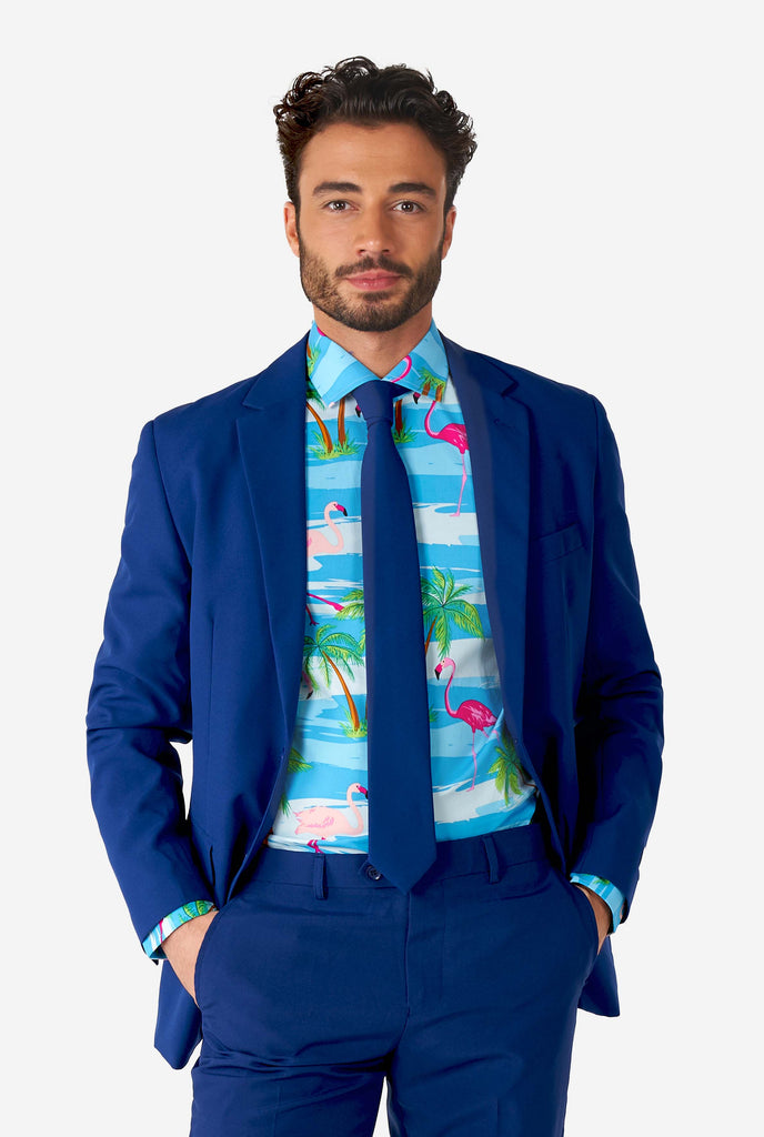 Man wearing Hawaiian dress shirt with tropical flamingo print an blue men's suit