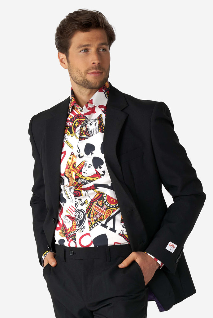 Man wearing dress shirt with playing card print and black men's suit