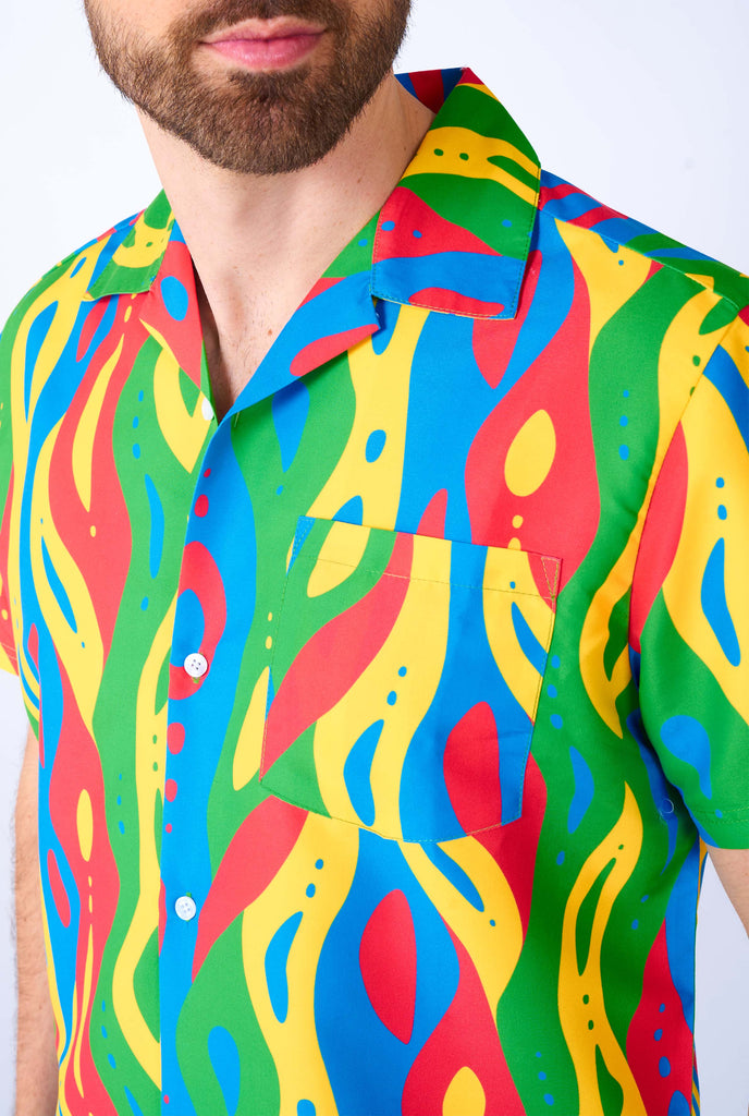 Man wearing colorful summer set, consisting of shirt and shorts. Close up.