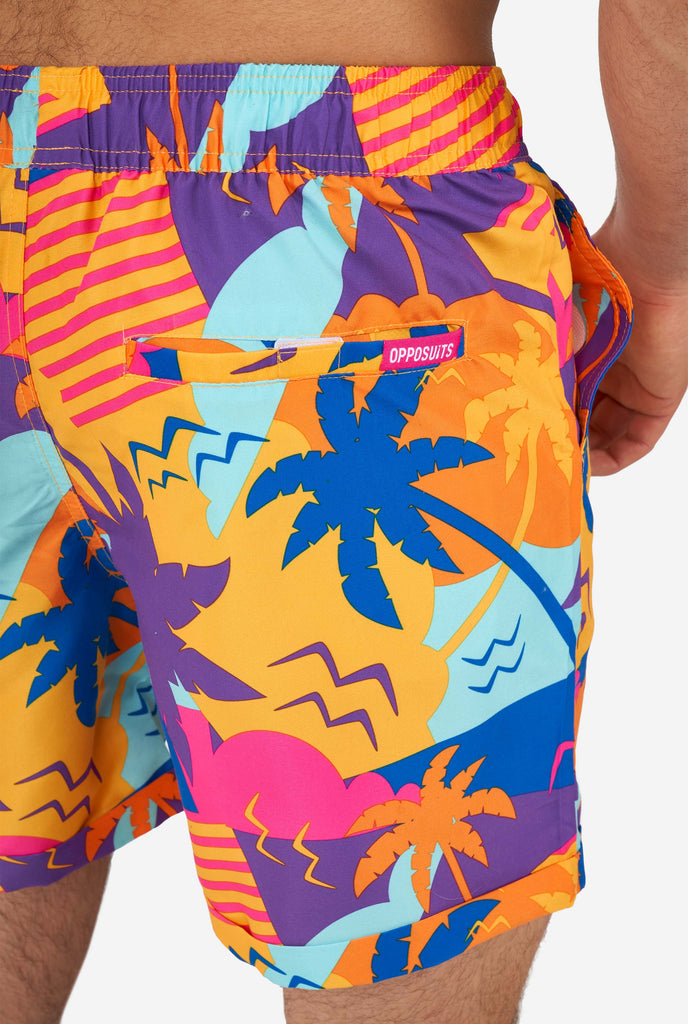 Man wearing colorful summer shorts, close-up from back