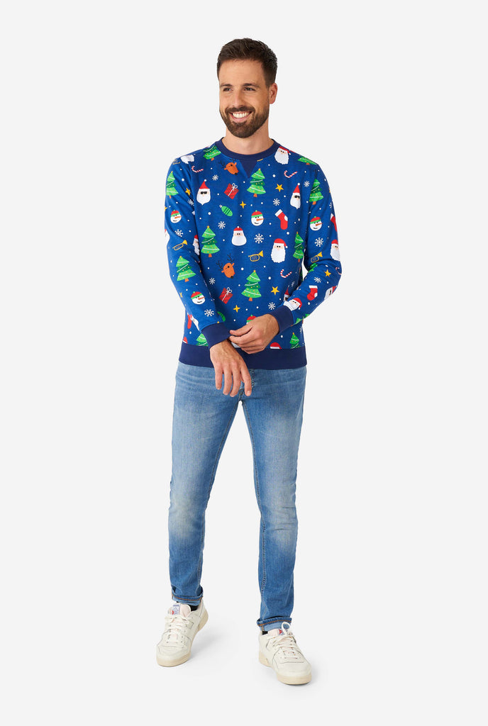 Man wearing blue Christmas sweater with Christmas icons