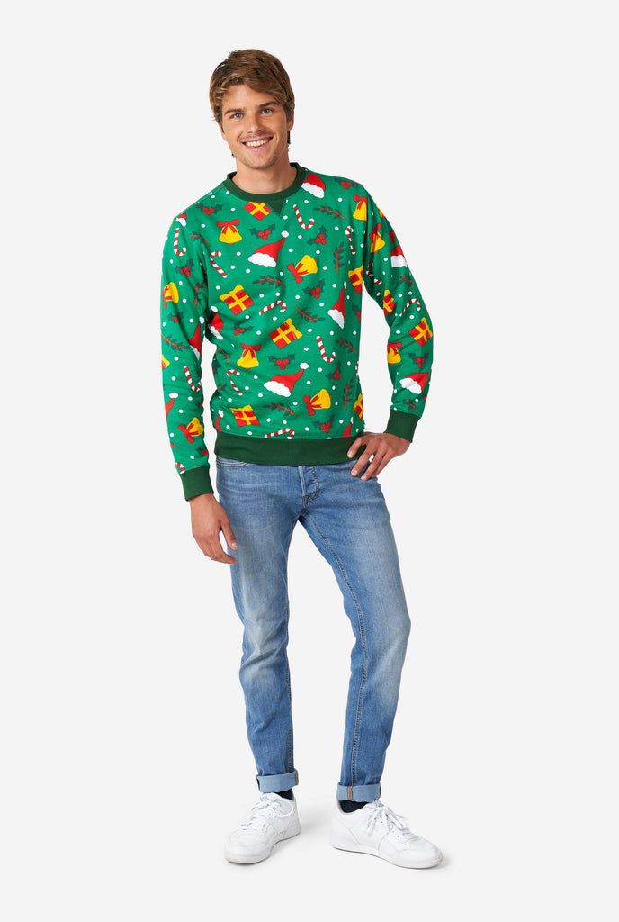 Man wearing green Christmas sweater with Christmas icons