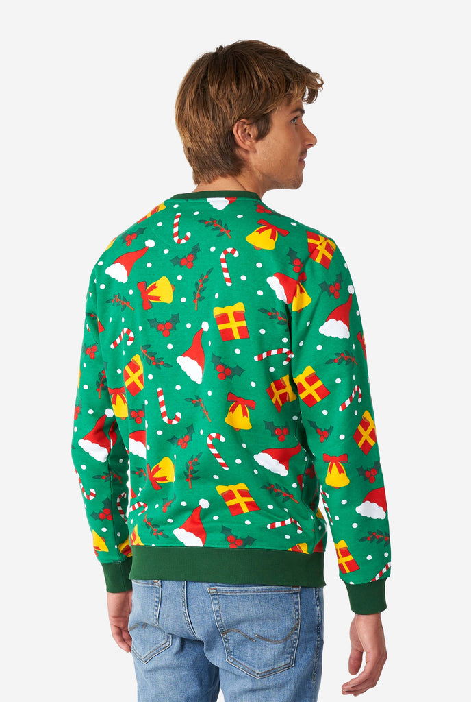 Man wearing green Christmas sweater with Christmas icons, view from the back