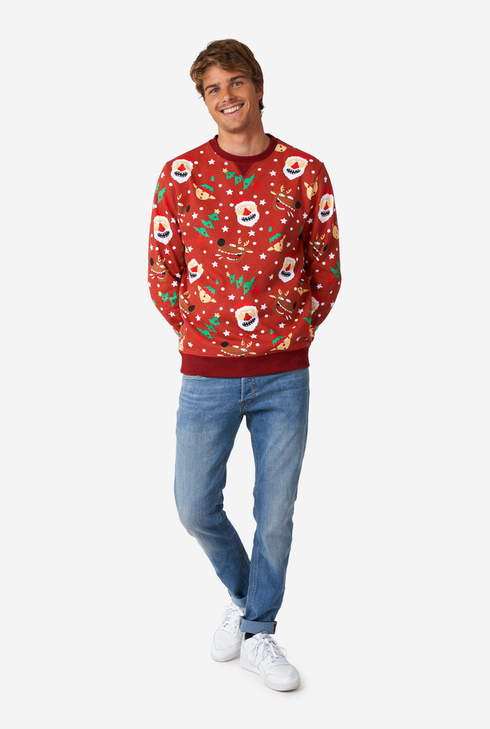 Man wearing red Christmas sweater with Christmas icons