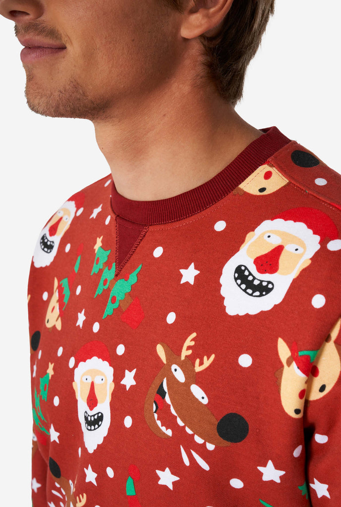 Man wearing red Christmas sweater with Christmas icons, close up