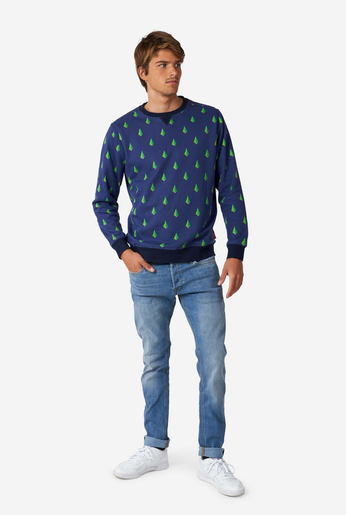 Man wearing blue Christmas sweater with Christmas tree print