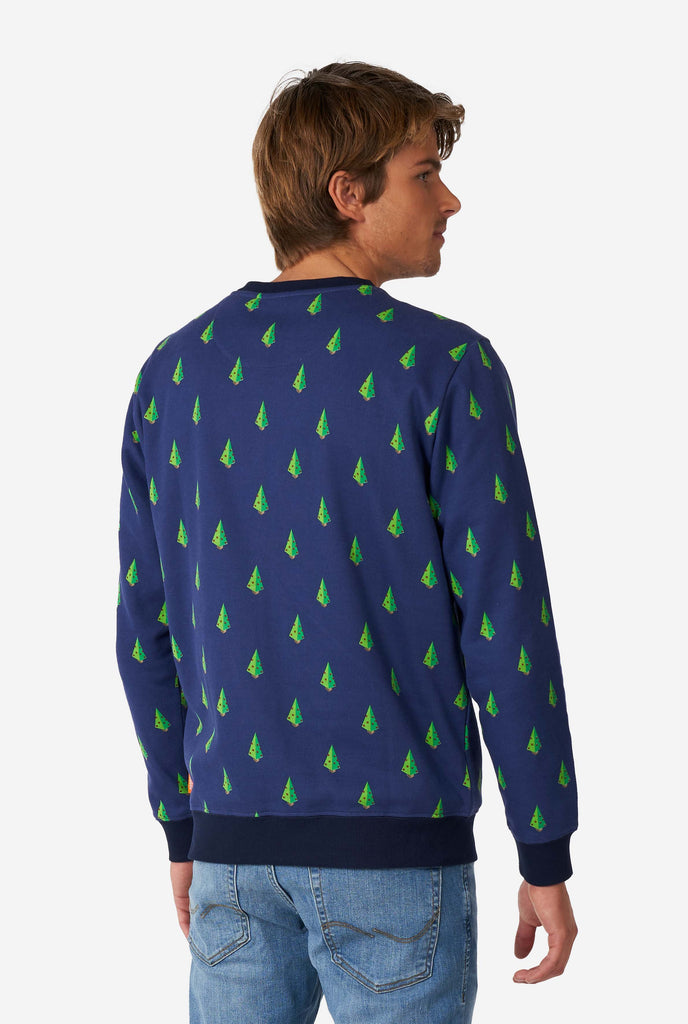 Man wearing blue Christmas sweater with Christmas tree print, view from the back