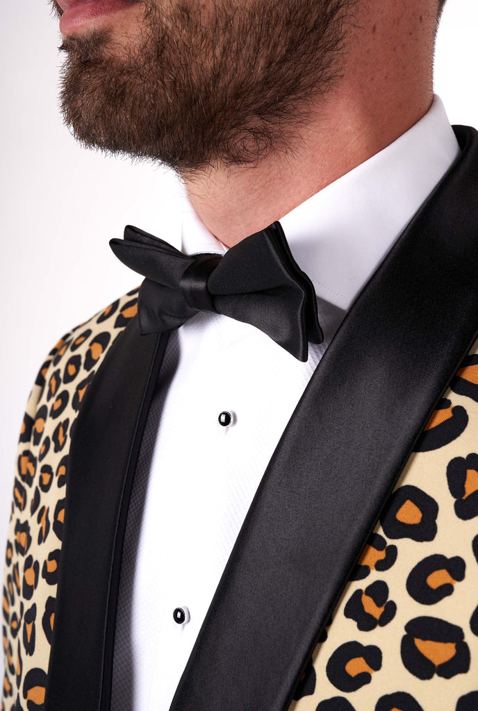 Man wearing tuxedo with jaguar print jacket, zoom