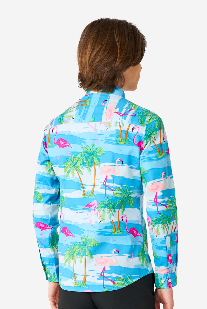 Teen wearing Hawaiian dress shirt with tropical flamingo shirt, view from the back