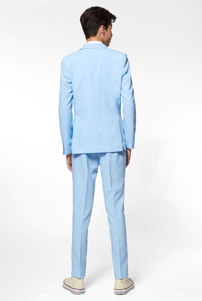 Teen wearing light blue formal suit, view from the back