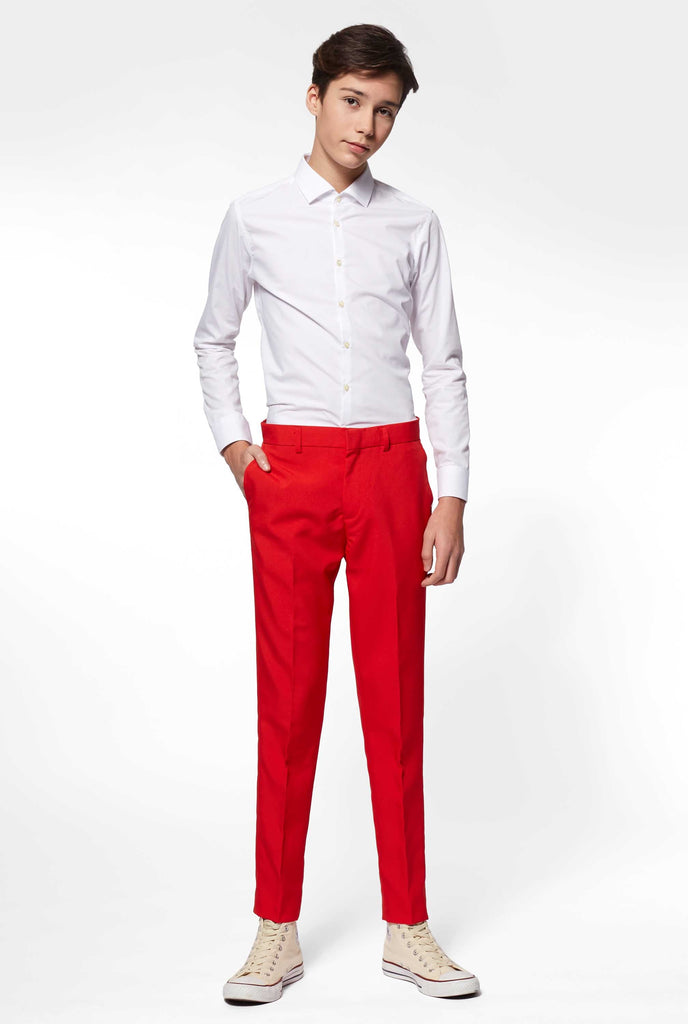Teen wearing red formal suit, view of the pants