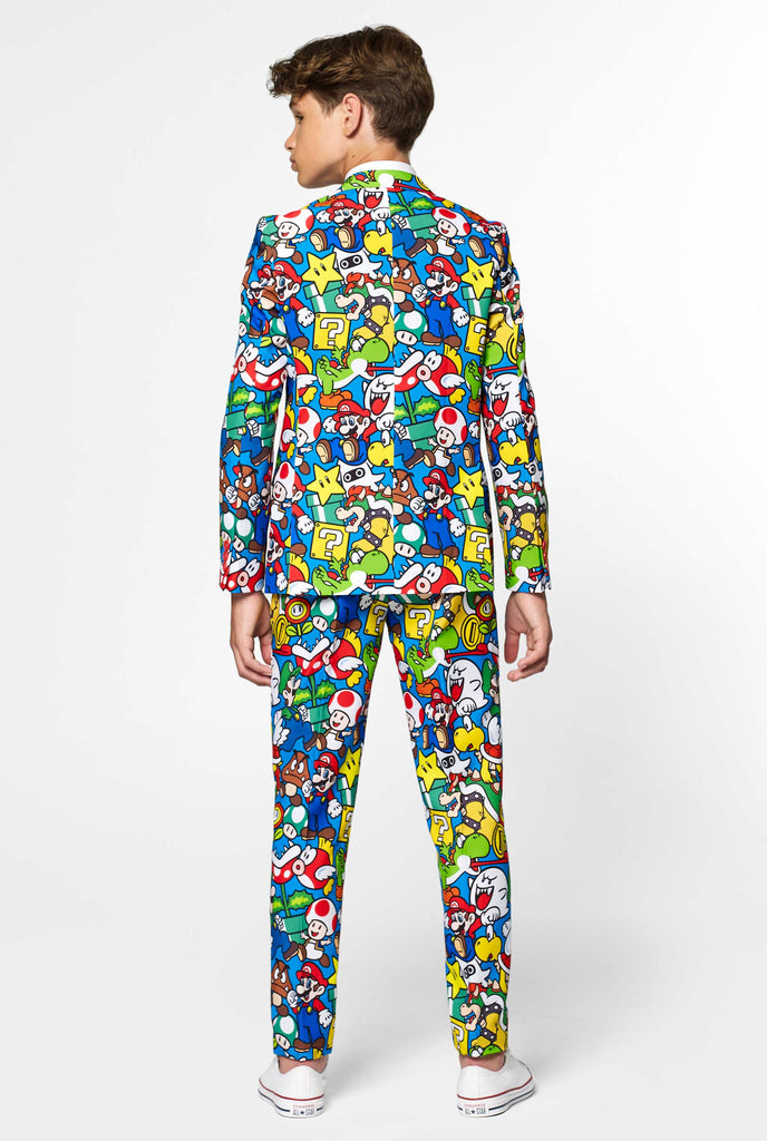 Teen wearing formal suit with colorful Super Mario print, view from the back