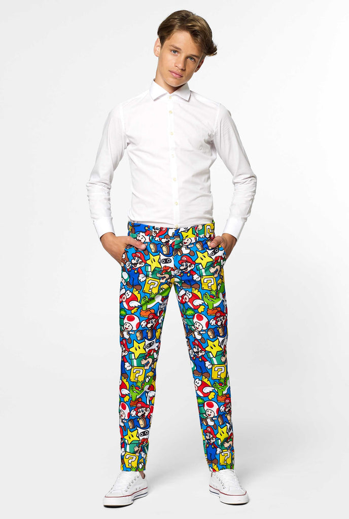 Teen wearing formal suit with colorful Super Mario print, view from the pants